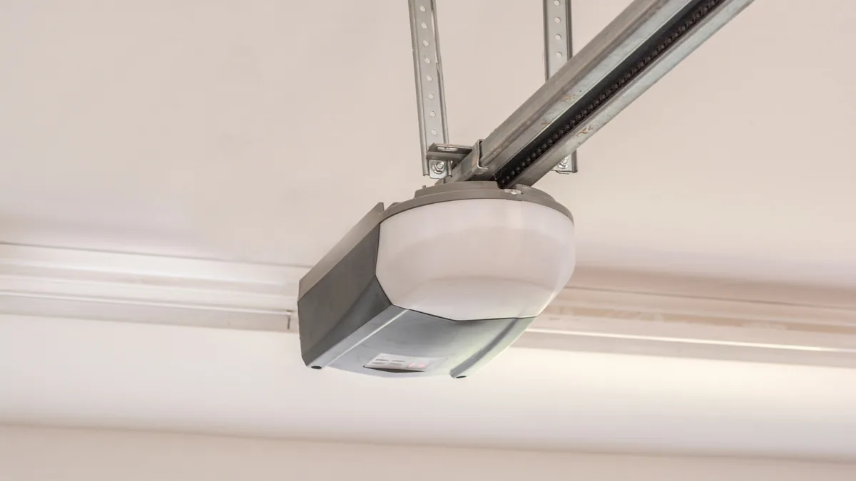 Close-up of a ceiling-mounted garage door opener and its rail.